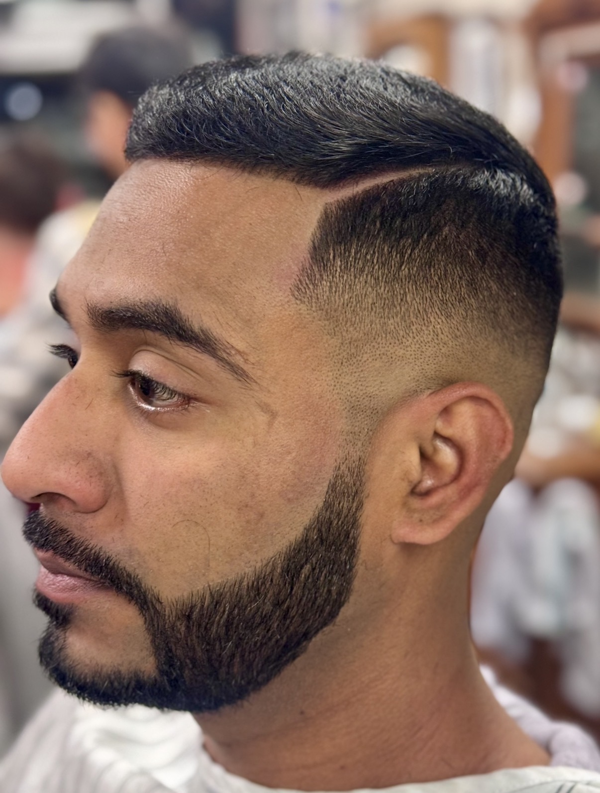 Sharp taper fade with a defined part, Cedar Park Barber-Allen